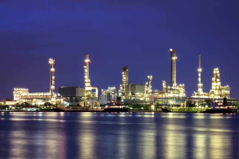 Oil refinery at twilight with reflection
